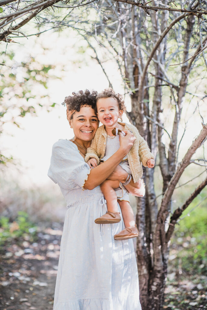 Mother and daughter in light blue and tan outfits in Littleton Colorado for a family photography session.